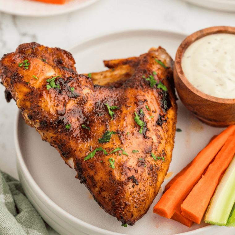Crispy chicken wings tossed in copycat Mrs. Dash salt-free seasoning on a white plate