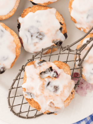 copycat panera blueberry scones with vanilla icing drizzle on cooling rack