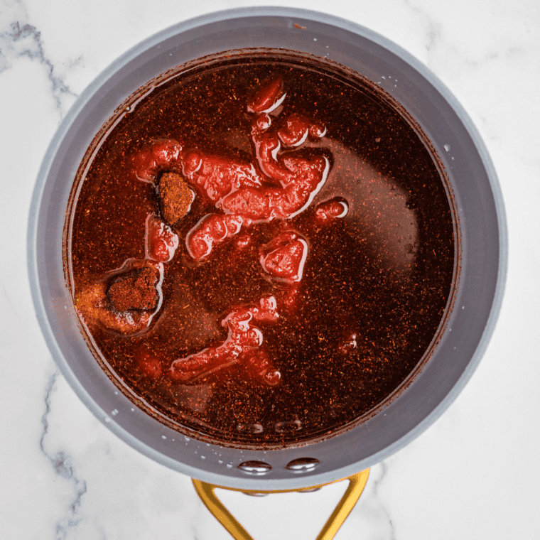 Hickory bourbon BBQ sauce simmering and thickening in a saucepan