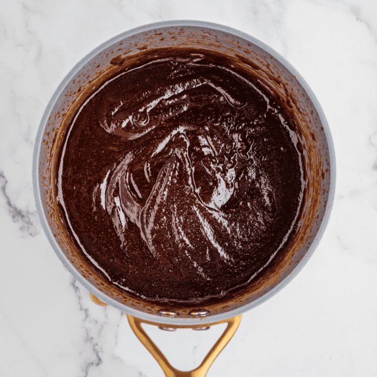 Glossy bourbon barbecue sauce being brushed onto grilled ribs