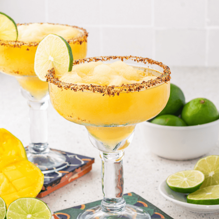 Margarita strained over fresh ice into a black salt-rimmed rocks glass