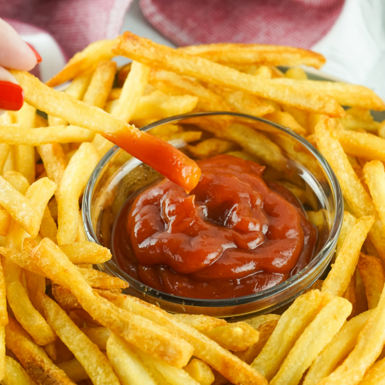Small bowl filled with homemade Hello Fresh Fry Seasoning spice blend on a wooden surface.