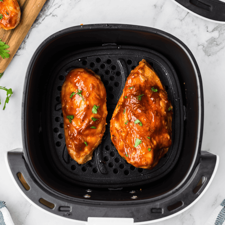 Cooked chicken being brushed with sticky Jack Daniel's whiskey glaze in the final minutes