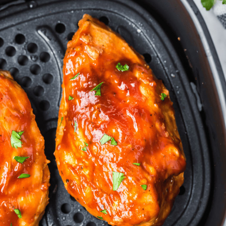 Finished Jack Daniel's chicken resting and drizzled with glossy whiskey glaze before serving