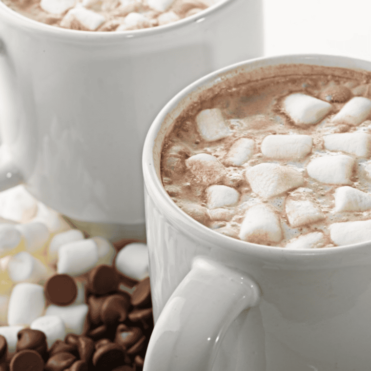 Stirring Jack Daniel's whiskey and vanilla into hot chocolate off the heat