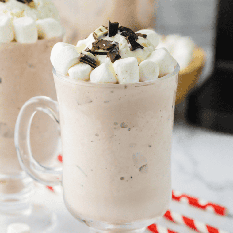 Jack Daniel's hot chocolate in a white mug topped with whipped cream and chocolate shavings