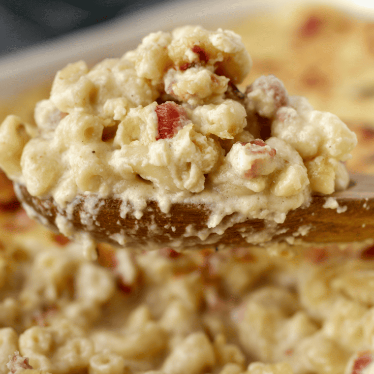 Cheesy Jack Daniel's mac and cheese pulled up on a spoon with a cheese stretch