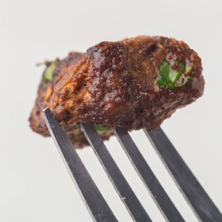 Close-up of spice blend featuring mixed peppercorns and herbs for steak seasoning.