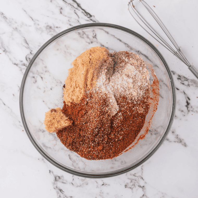 Flour, cornstarch, beef bouillon, and spices in a bowl for homemade brown gravy mix