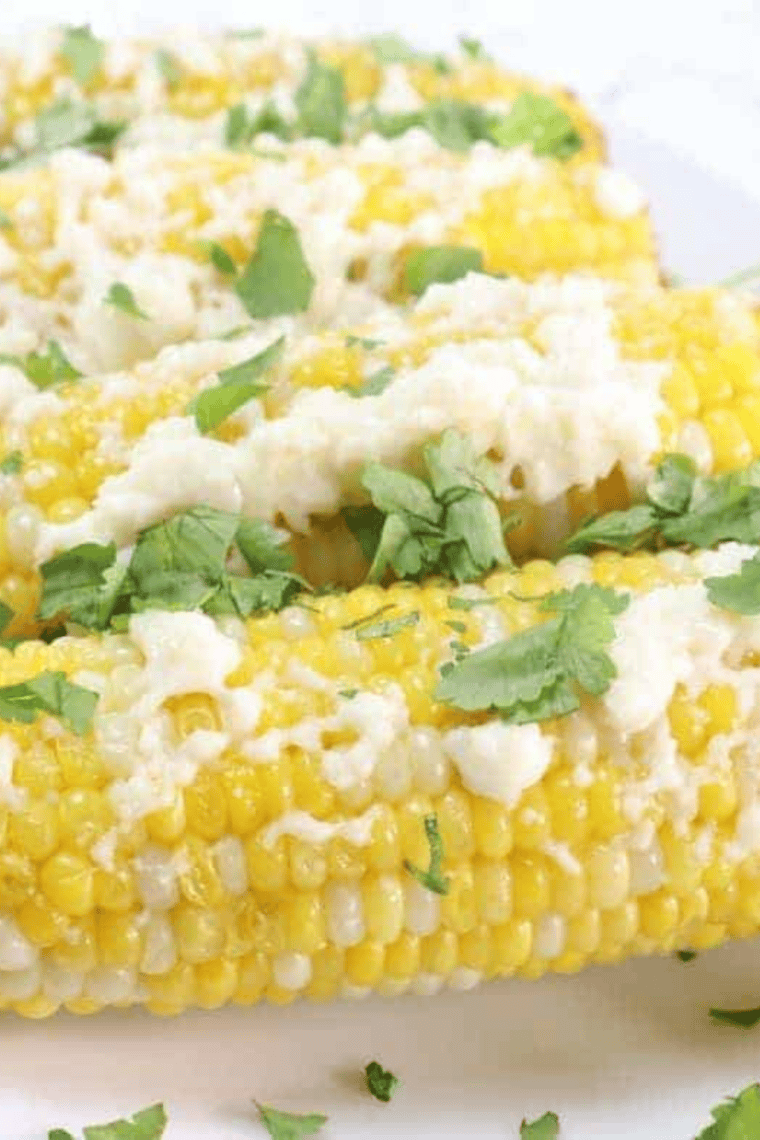Mexican mayonesa con limón brushed over grilled elote with cotija and chili powder