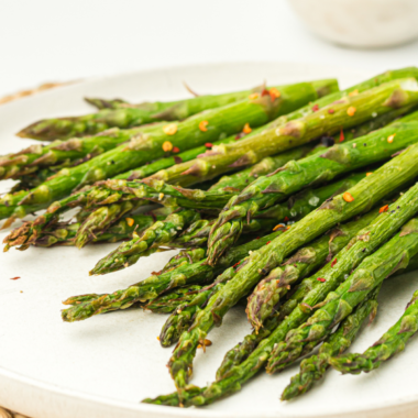 Ninja Crispi asparagus spears cooked crispy and golden in an air fryer basket