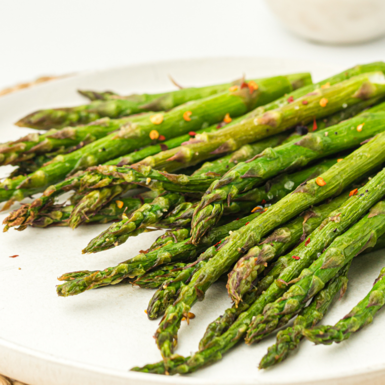 Ninja Crispi asparagus spears cooked crispy and golden in an air fryer basket