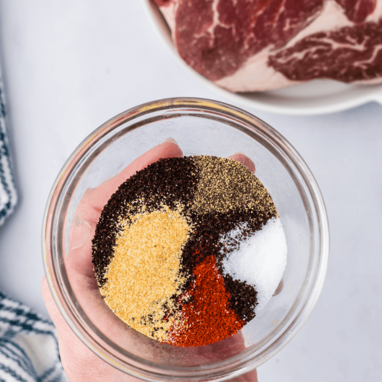 Bone-in ribeye seasoned with kosher salt and coarse black pepper before searing