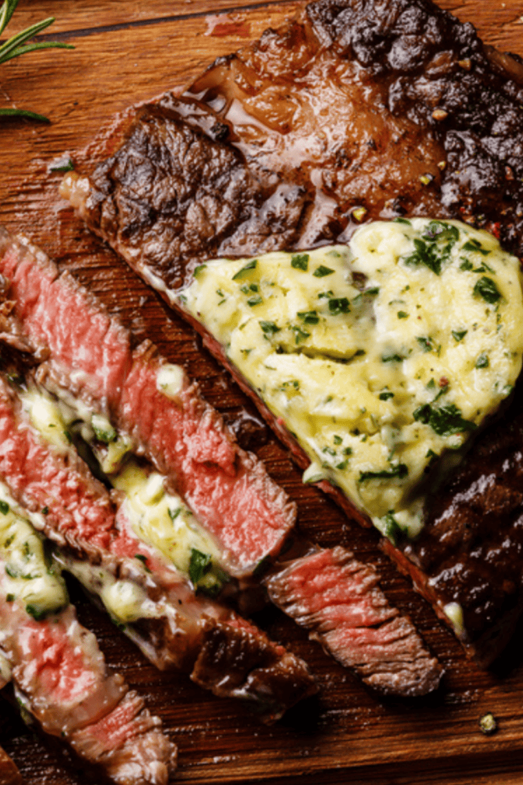 Spooning foaming garlic and thyme butter over a searing Cowboy Ribeye steak