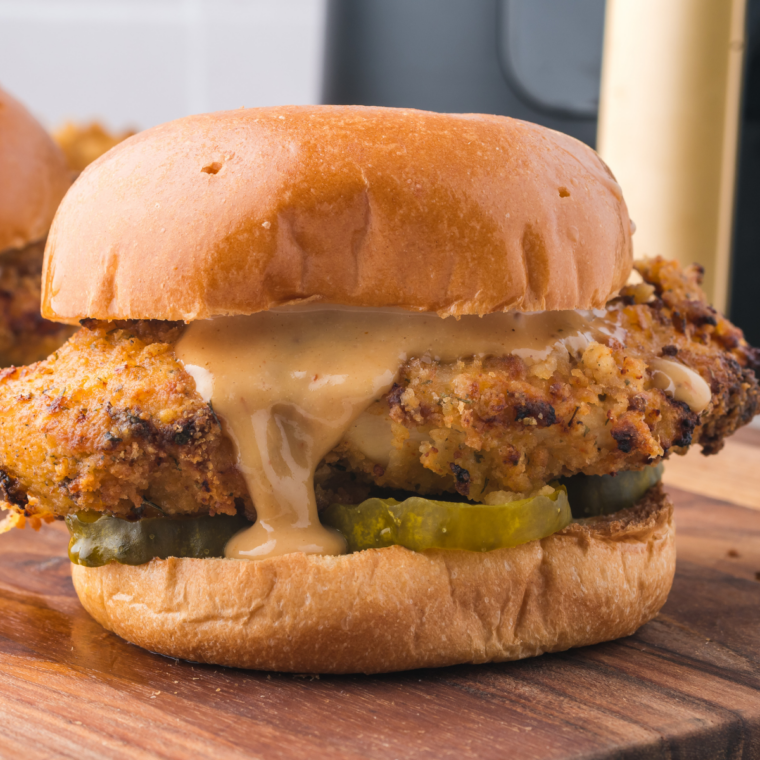 Homemade Chicken Big Mac copycat stacked tall with special sauce dripping down a sesame seed bun