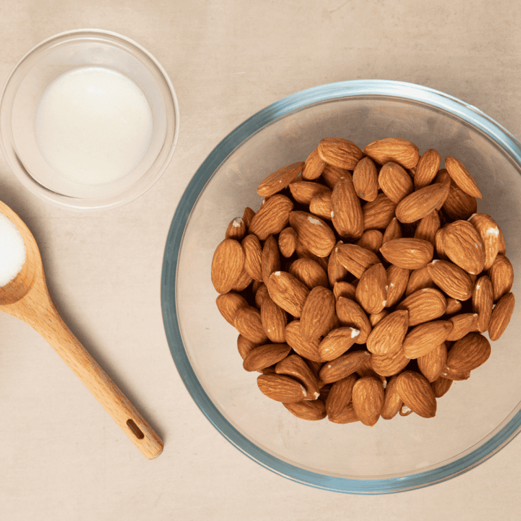 Ingredients for air fryer almond butter: raw almonds, salt, honey, and cinnamon