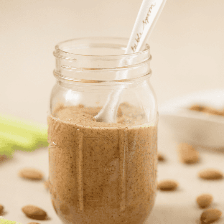 Homemade almond butter spooned into a glass storage jar