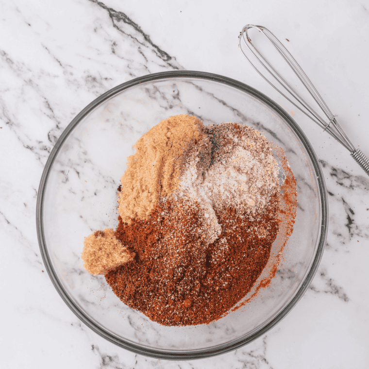 Baby back ribs dry rub mixed in a glass bowl