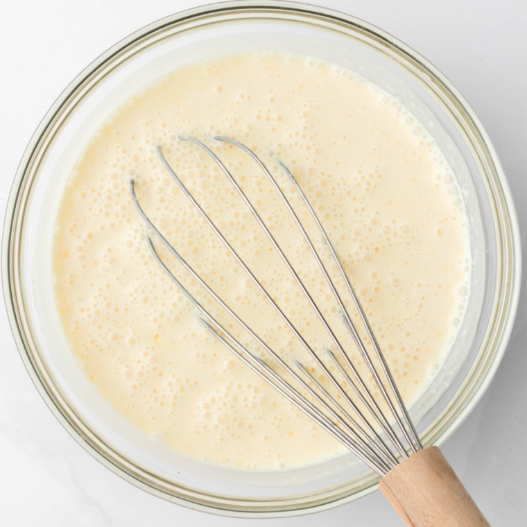 Whisking the vanilla ice cream base in a glass measuring cup until the sugar dissolves.