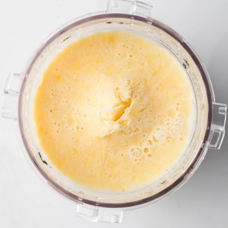 A frozen Ninja Creami pint of vanilla ice cream base ready to spin.