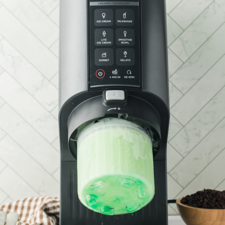 Freshly spun mint ice cream in a Ninja Creami pint after the Ice Cream function, smooth and pale green.