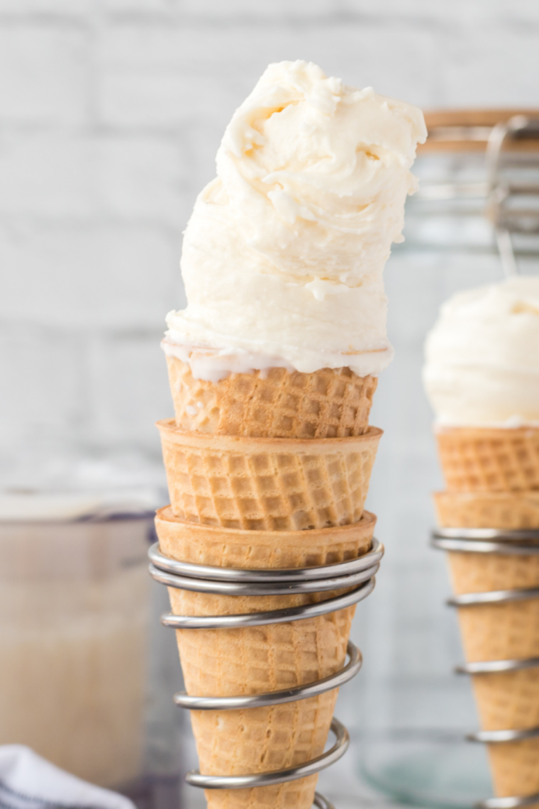 Scoop of homemade Blue Bell Sweet Cream Ninja Creami ice cream in a crispy waffle cone