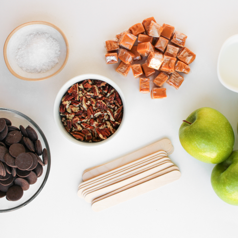 Ingredients for chocolate turtle caramel apple pops: Granny Smith apples, melting chocolate, pecans, and caramel squares