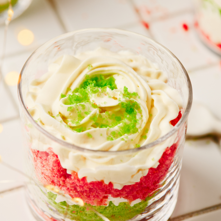 Layering red velvet cake and cream filling into a glass trifle dish