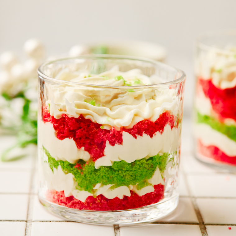 Chilled Christmas trifle dessert scooped onto a plate showing red and green layers