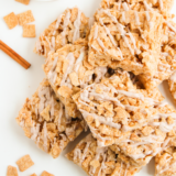 Cinnamon Toast Crunch Rice Krispie Treats sliced into bars with cinnamon white chocolate drizzle