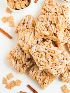 Cinnamon Toast Crunch Rice Krispie Treats sliced into bars with cinnamon white chocolate drizzle