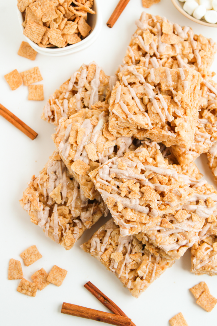 Cinnamon cereal treats cut into twelve bars on a wooden cutting board