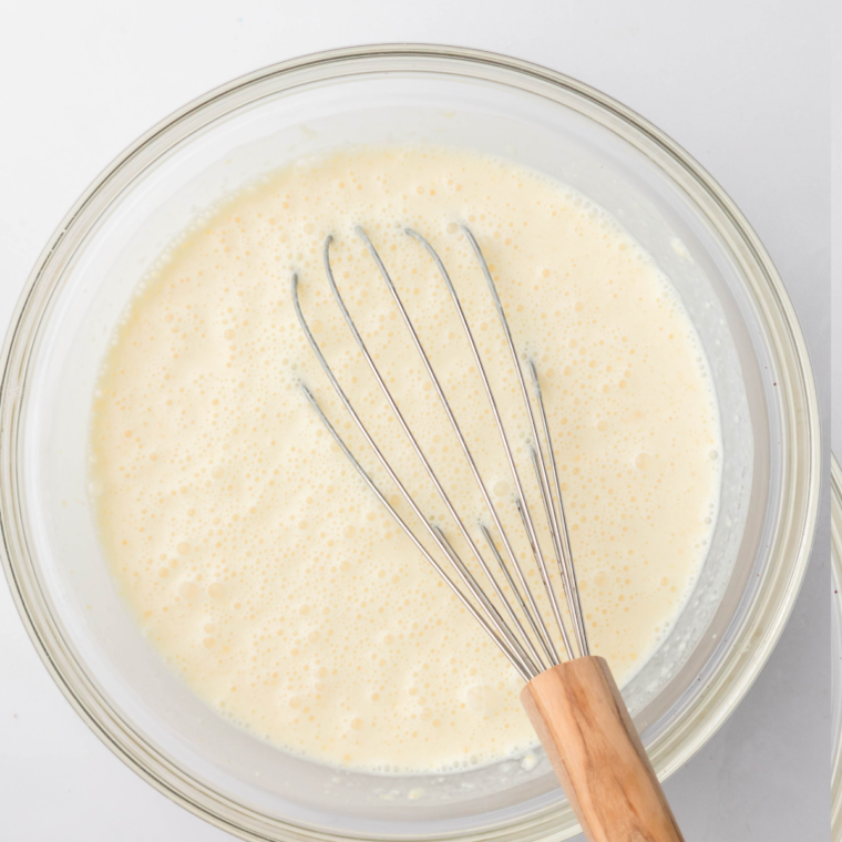 Whisking milk, cream, sugar, and cake mix into a smooth base for Cold Stone Cake Batter Ninja Creami