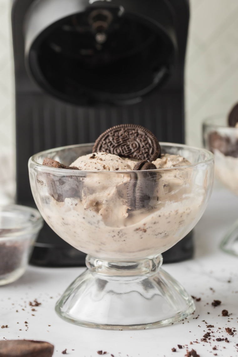 Scooping Founder's Favorite Ninja Creami copycat from a pint with visible brownie and pecans