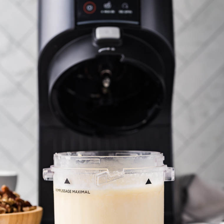 Pouring Founder's Favorite ice cream base into a Ninja Creami pint before freezing