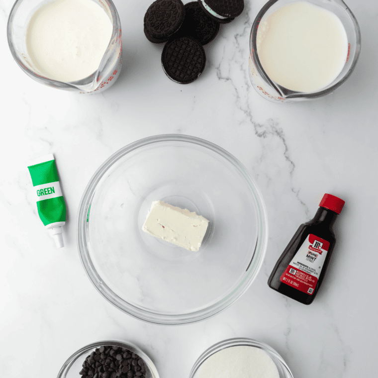 Ingredients for Ninja Creami mint chocolate chip ice cream: heavy cream, milk, sugar, cream cheese, peppermint extract, mini chocolate chips, and brownie