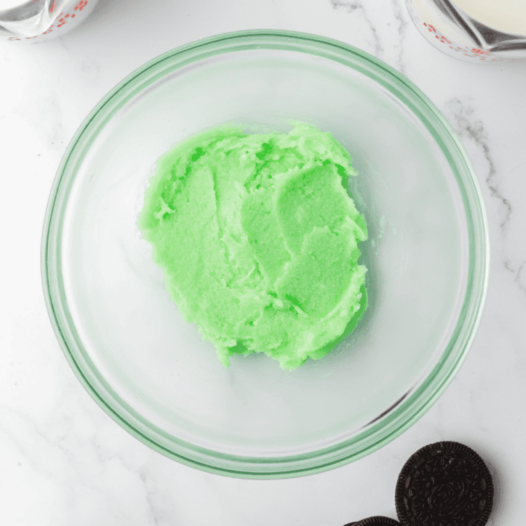 Mint ice cream base poured into a Ninja Creami pint container below the max fill line