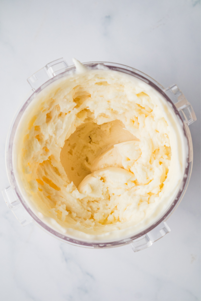 Bowl of copycat Cold Stone Sweet Cream Ice Cream from the Ninja Creami, dense and pale with a smooth scooped surface