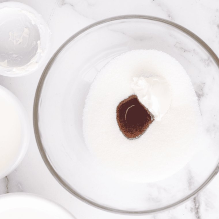 Whisking softened cream cheese with sugar and vanilla pudding mix until smooth for Cold Stone sweet cream ice cream