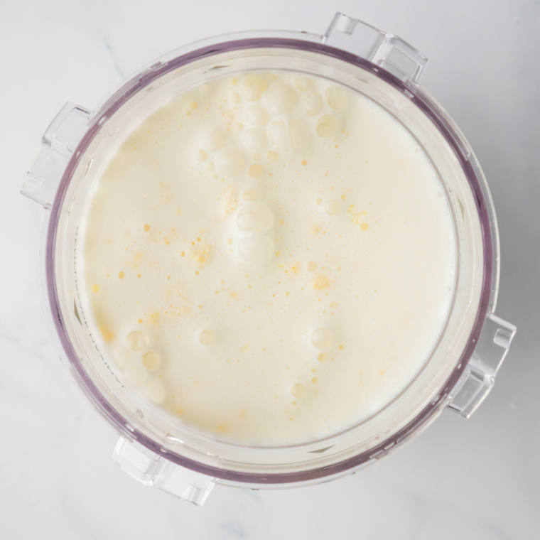Banana pudding ice cream base poured into a Ninja Creami pint below the max fill line