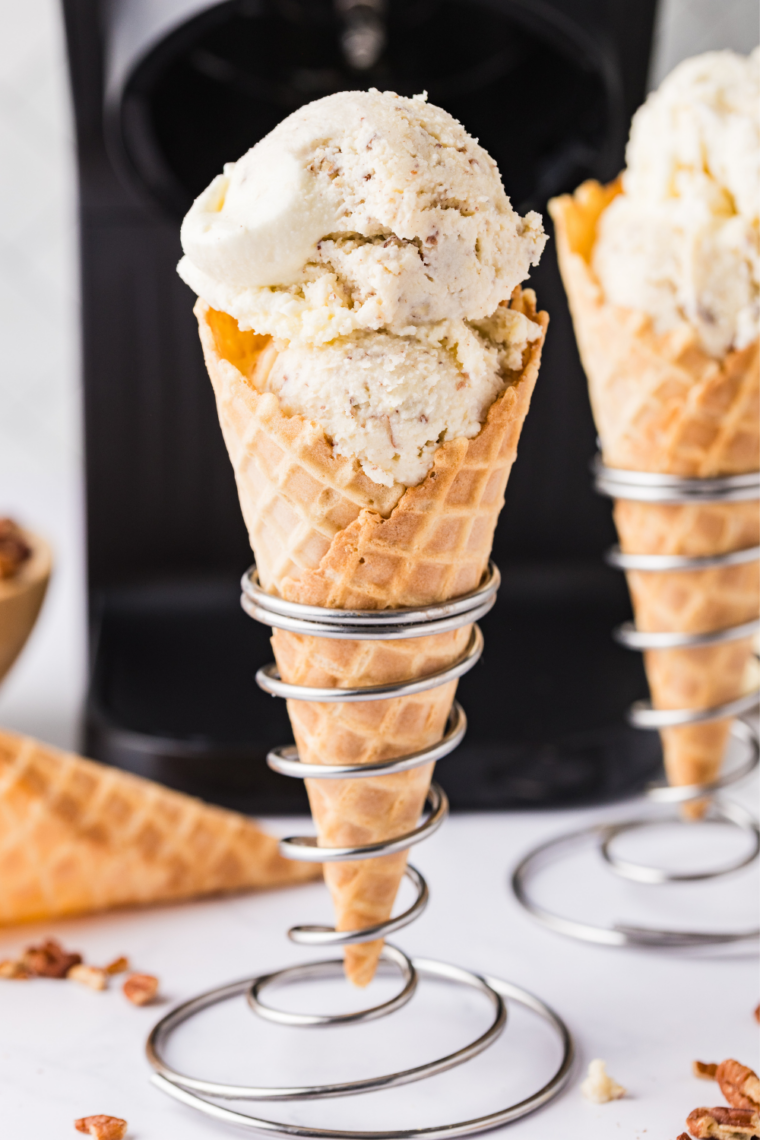 Scoop of homemade Ninja Creami butter pecan ice cream in a waffle cone