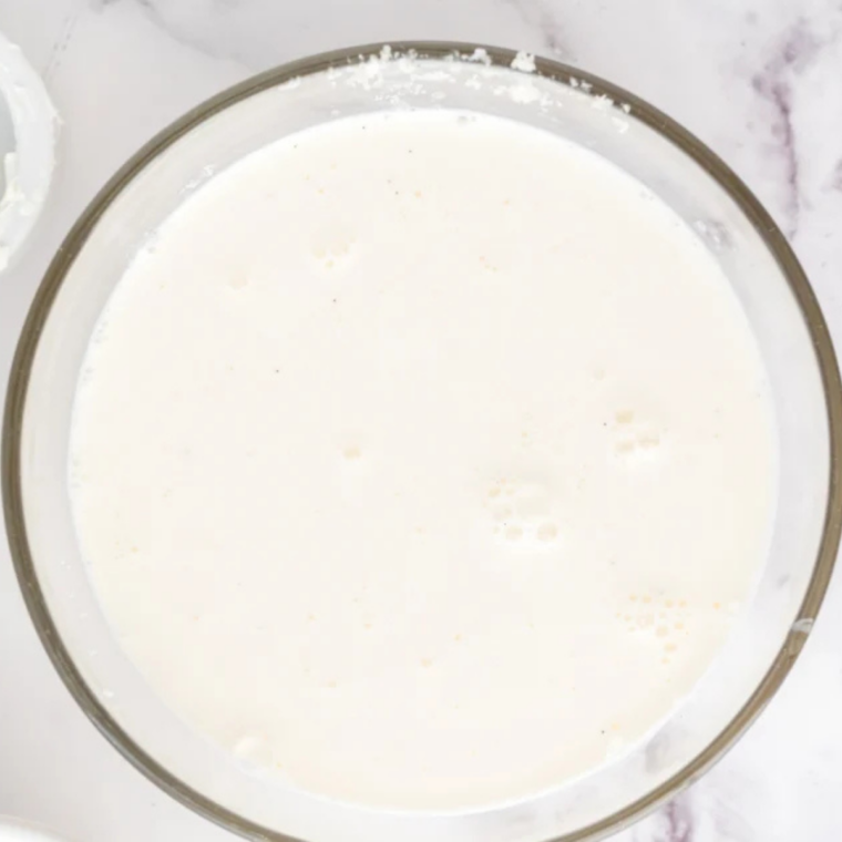 Cream and milk heating in a saucepan until steaming