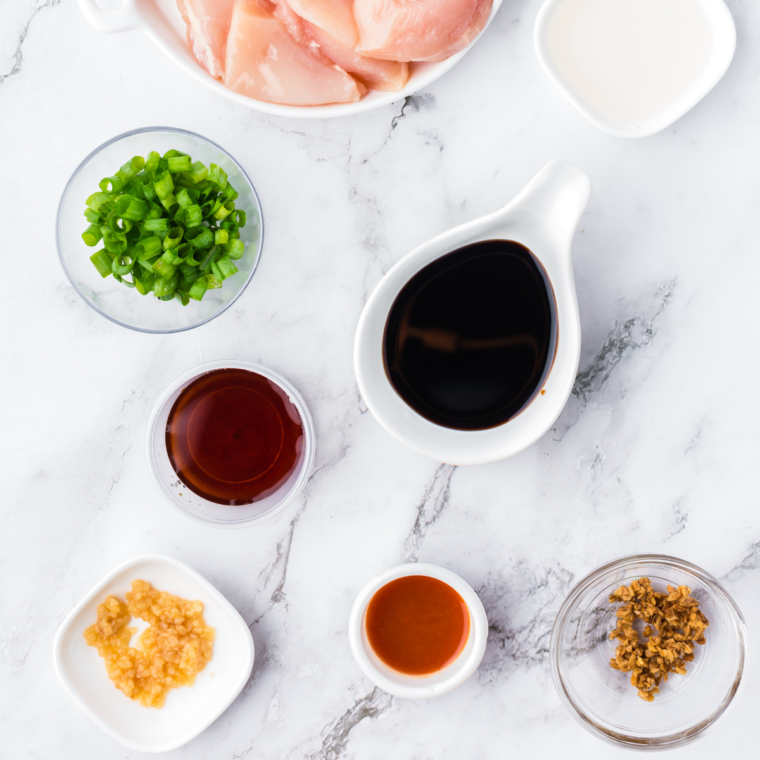 Ingredients for copycat Lawry's teriyaki marinade laid out: pineapple juice, soy sauce, brown sugar, ginger, and garlic