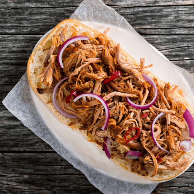 Shredded al pastor pork tossed with copycat McCormick seasoning in a skillet