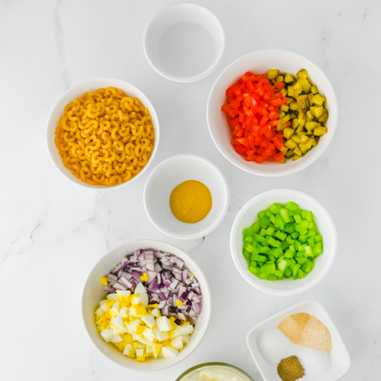 Ingredients for cottage cheese pasta salad: cottage cheese, elbow macaroni, Italian dressing, and fresh vegetables
