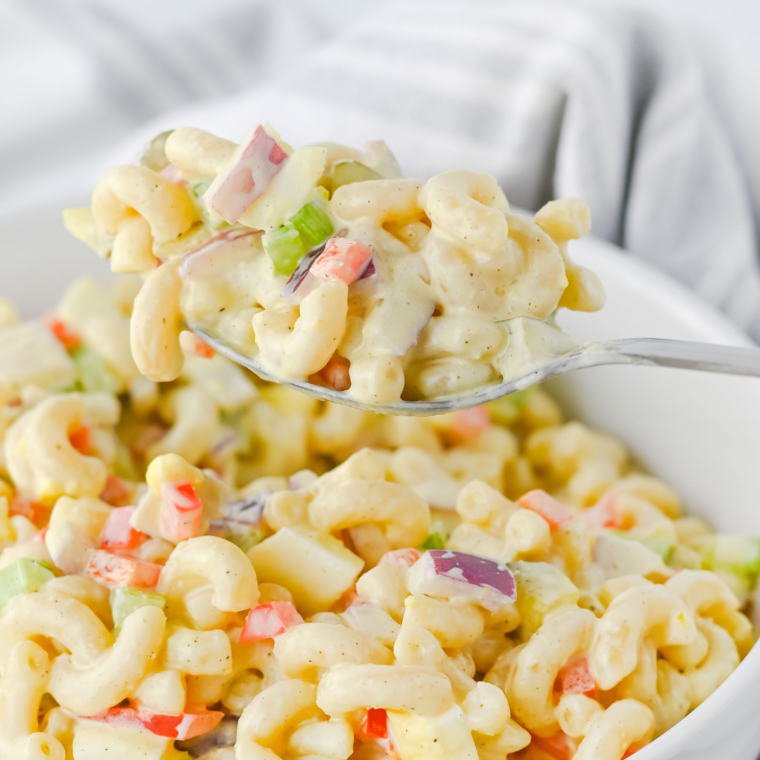 Creamy cottage cheese pasta salad with elbow macaroni, tomatoes, and cucumber in a white bowl