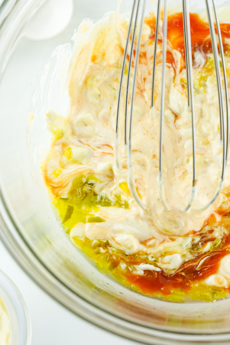 Paprika, turmeric, and garlic powder sprinkled over the pale orange sauce base