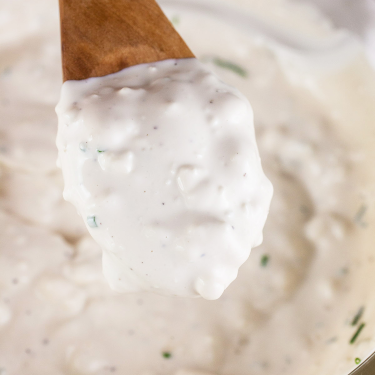 Whisking garlic, anchovy paste, Dijon, Worcestershire, and lemon juice for LongHorn Caesar dressing