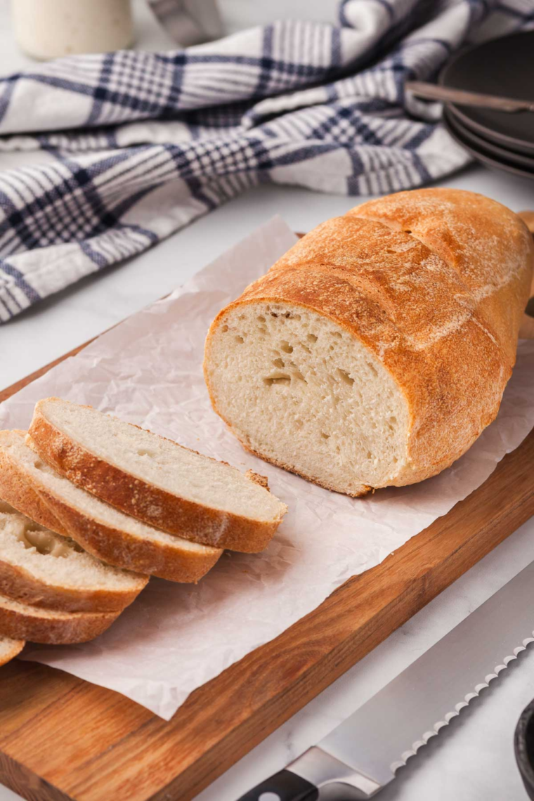 Copycat Longhorn Steakhouse bread sliced to show soft honey wheat crumb with whipped butter
