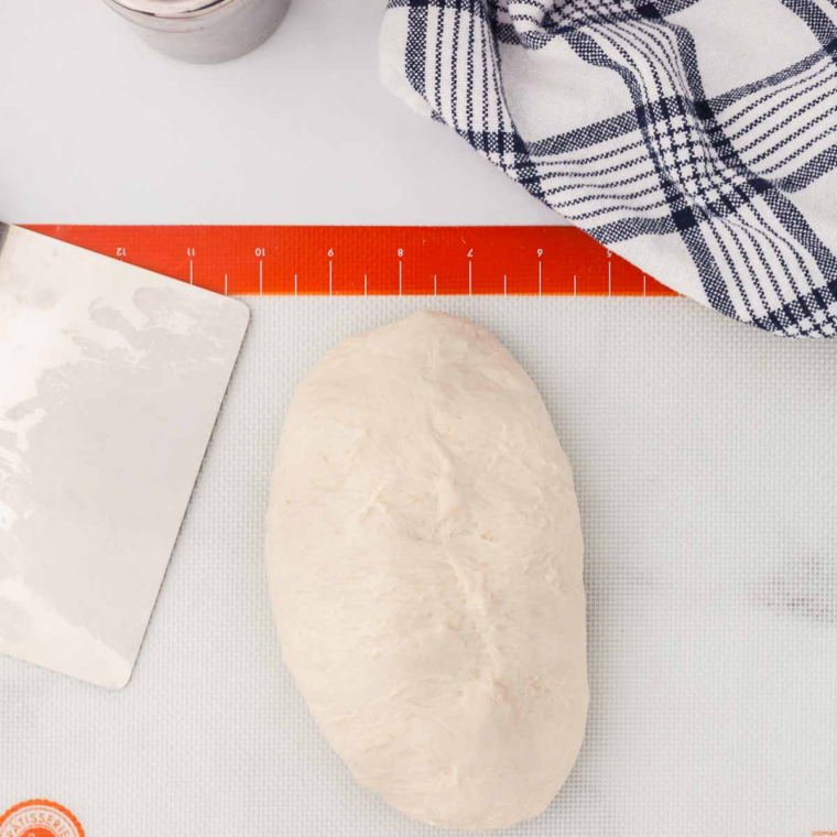 Rolling Longhorn Steakhouse bread dough into a loaf and pinching the seam closed